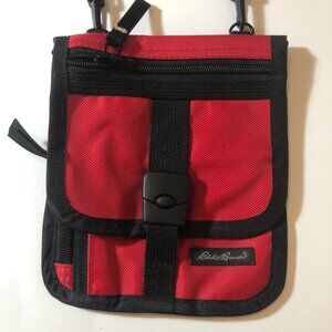 Elevate Your Look: Sleek Black Bag with a Pop of Red Inside!